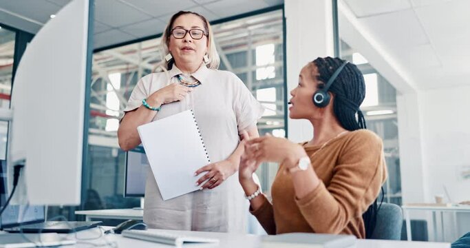 Call center, customer service and training with a woman manager teaching an employee about telemarketing. Crm, contact us and coaching with a supervisor talking to a female sales consultant at work