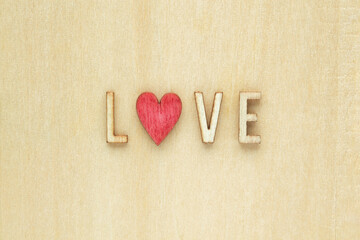 Wooden letters spelling out Love with a red heart.