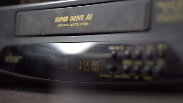 Vhs Tape Being Placed Into Dusty Tape Deck and press to play