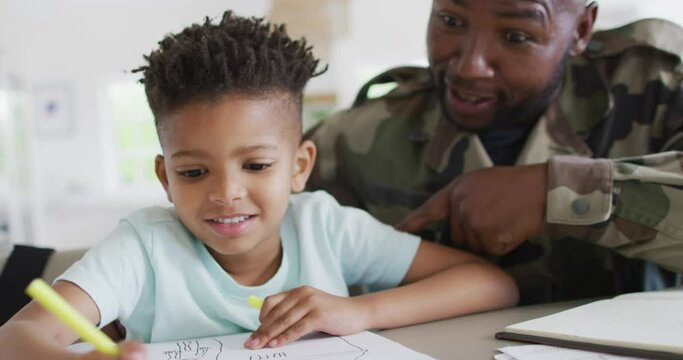 African american father with son learning together and writing