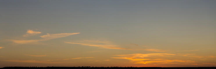 Panorama. Landscape with dawn. The sun rises through light cirrus clouds.