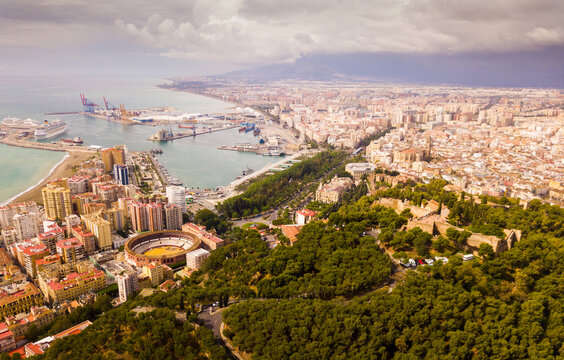 Panoramic view of bullring and port of Malaga on cloudy day, Spain - Powered by Adobe
