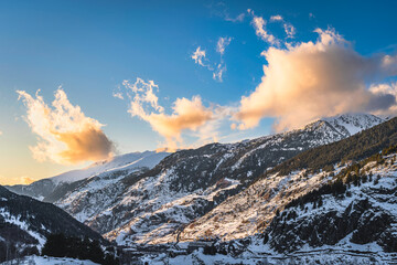 Beautiful winter scenery with El tarter village and mountains illuminated by sunset. Ski winter holidays in Andorra, Pyrenees Mountains - obrazy, fototapety, plakaty