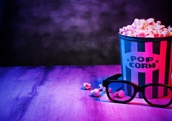 Cinema movies concept background, with a pop corn bucket, 3D glasses and copy space for text. Movie...