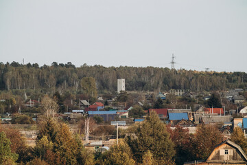 View of a small town, surrounded by forest and nature. City landscape.