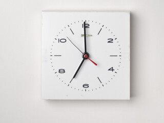 A clock on a white background. It is 7 o'clock. Concept, nobody.
