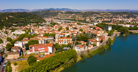 Scenic aerial view of French commune of Givors on banks of Rhone river on summer day, Metropolitan Lyon