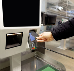 Customer pays his purchase at the supermarket,self checkout systems in  retail stores,Barcode scanner,Self checkout machine