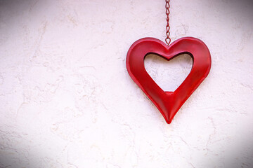 Red heart on the white wall. Valentines day background. Copy space.