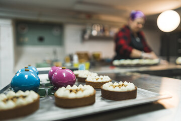 view of delicious baked cookies and a baker in the background, dessert concept. High quality photo