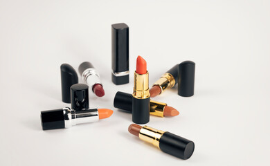 A set of various lipsticks on a white background.