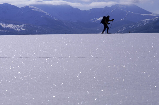 A person walking on a frozen landscape, Rocky Mountains, Colorado, USA.