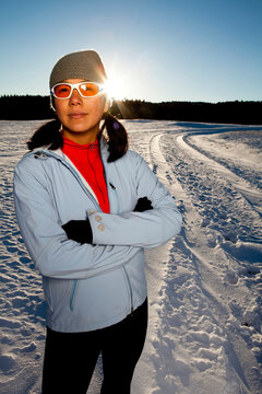 a Japanese-American woman has her portrait taken after running down a snowy road in Custer State, South Dakota.