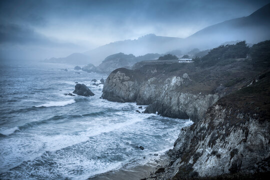 Pacific ocean waves crash the rocky beach coast in California by the Cabrillo highway US 1.