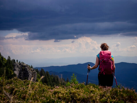 Women hiker standing above mountains towards valley at Col de la Schlucht in Vosges, Alsace, France