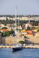 Sailboat near Historic Old Town in City on the Mediterranean Sea, Rhodes, Greece.