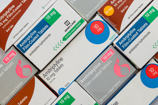 Boxes of various generic brands of 10mg Amitriptyline Hydrochloride tablets in diagonal flat-lay