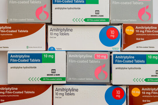 Boxes of various generic brands of 10mg Amitriptyline Hydrochloride tablets in horizontal flat-lay