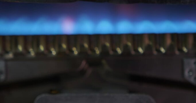 Lighting fire on gas burner ,Close-up. Kitchen burner turning on. Gas stove at home