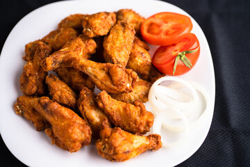 Hot chicken wings with honey and parmeisane cheese