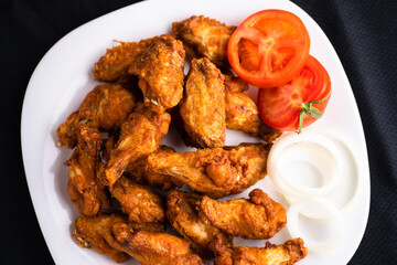Hot chicken wings with honey and parmeisane cheese