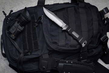 Tactical equipment, briefcase, combat knife and night vision device.