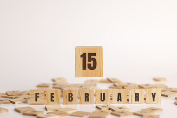 February 15  displayed wooden letter blocks on white background with room for print