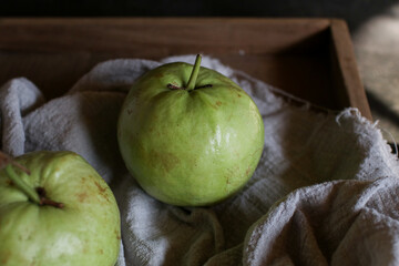 Guava fruit with leaf on white wooden dark background. Fresh organic Tropical high vitamin C fruit, Healthy eating.