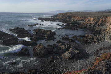 waves crashing on rocks and cliffs in california