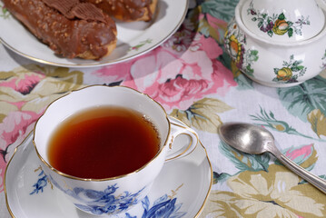Porcelain cup tea Chocolate eclairs