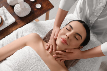 Young woman enjoying professional massage in spa salon, above view