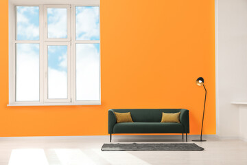 Beautiful interior with sofa and floor lamp near orange wall