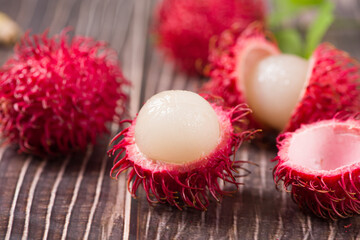 fresh ripe rambutan fruit on wooden table