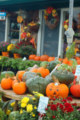 Pumpkins and squash are for sale at a roadside farm during an autumn day near Halloween in the fall