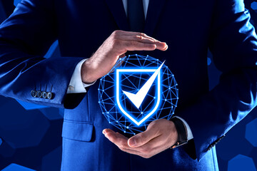 Anti-fraud security system. Man with illustration of checkmark in shield on dark blue background,...