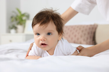 Fototapeta premium Mother with her little baby on bed in room, closeup