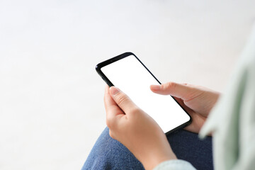 Closeup view of woman with smartphone indoors. Space for text