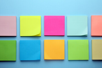 Paper notes on light blue background, flat lay