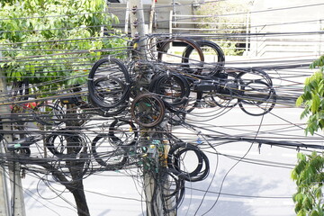 Messy electric cables on the concrete electric pole, not safety cables, Street electrical unsafe power lines