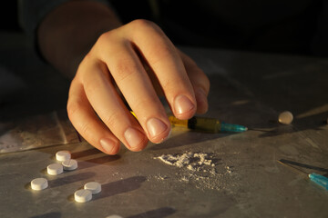 Addicted man with drugs at grey textured table, closeup