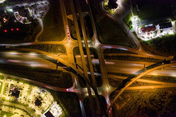 Aerial view on junction at night. Traffci on higway in evening time. long exposure from drone on roads.