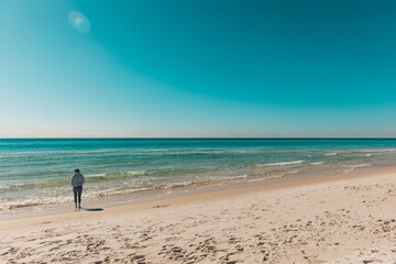 person walking on the beach