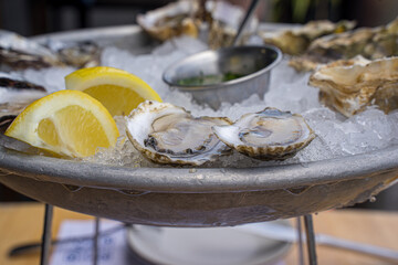 Enjoying raw seafood. Depend on the country, raw seafood can be served in different style, some will serve with crackers, tabasco, hot sauce, vinegar, and lime while others serve with salt, pepper