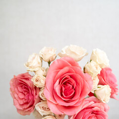 Flat lay of coral and pale pink roses on linen background