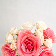 Flat lay of coral and pale pink roses on linen background