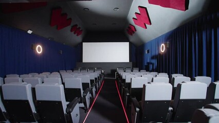 Push In Aisle Past Seating In Cinema Theatre Facing Projector Big Screen, 4K