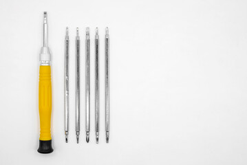 universal screwdriver with a set of interchangeable bits on a white background