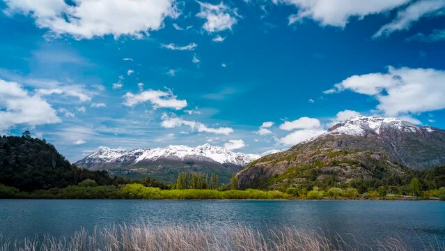 timelapse of snow capped Andes in Chile view from Futaleuf&uacute; looking over Laguna Espejo lake small town in Northern Patagonia Located at the confluence of the Espolon Los Lagos