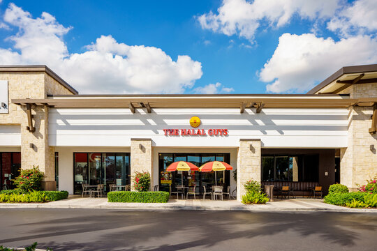 Photo of shops and restaurants at Tower Shops outdoor mall Davie Florida. The Halal Guys