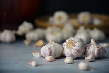 Close-up shot of garlic laying on gray stone table